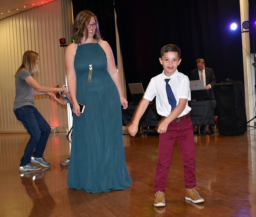 Daniel Hetzer shows his mom Rachel how to floss.