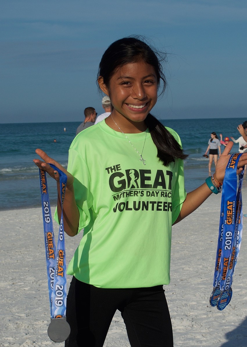 Mirabell Torres of Braden River Middle School helped out by handing medals to the finishers.