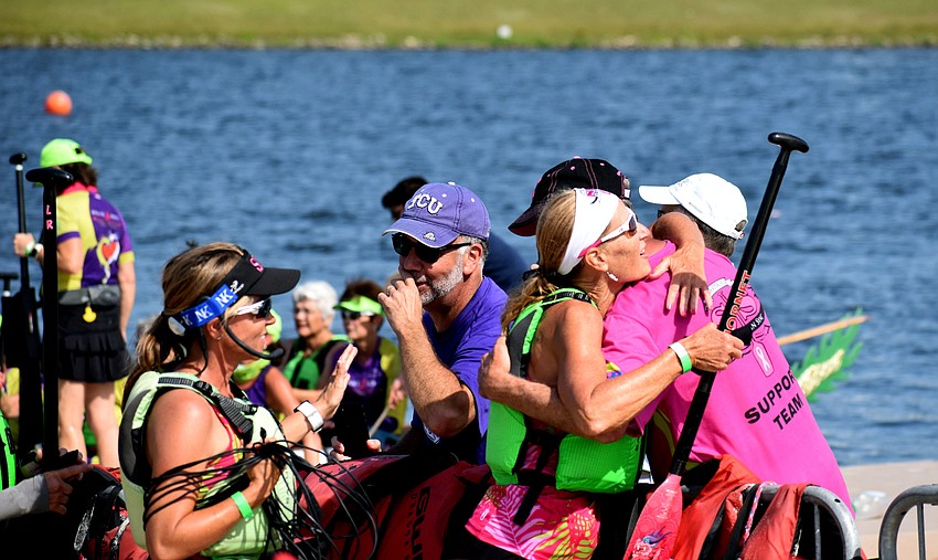 Venice resident Joni Carone collects a hug after Survivors in Sync won a race.