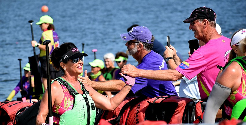 Lakewood Ranch's Carla Baldwin gives high fives as she returns from a race.
