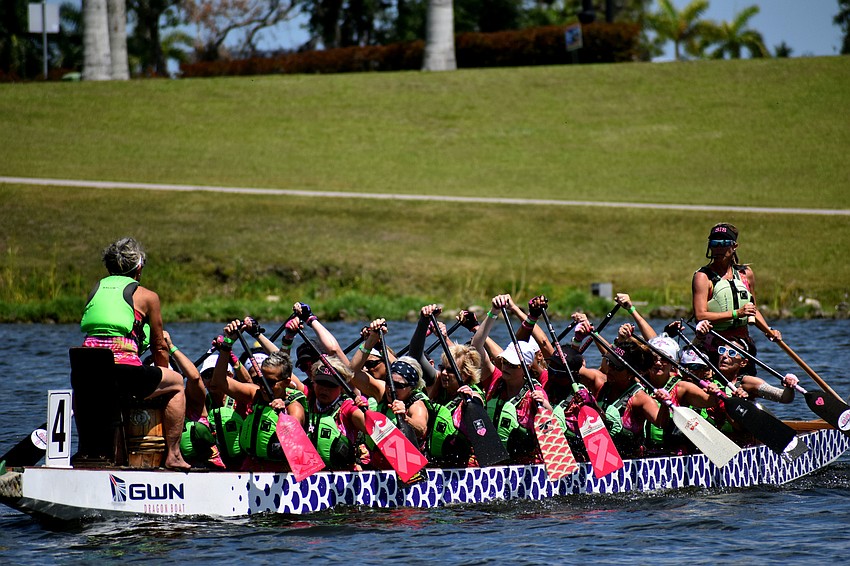 Members of Survivors in Sync have breast-cancer themed paddles.