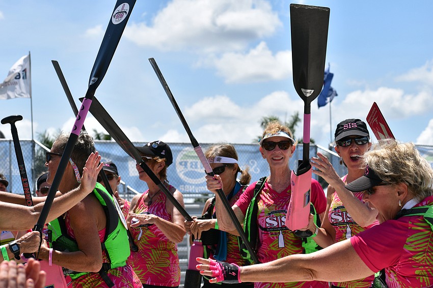 Betty Jo Craig and Heidi Smithers, right in the white visor and black cap,  welcome back Survivors in Sync teammate JoAnn Moore.