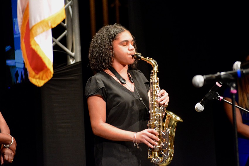 Zionna Williams plays the National Anthem on her saxophone
