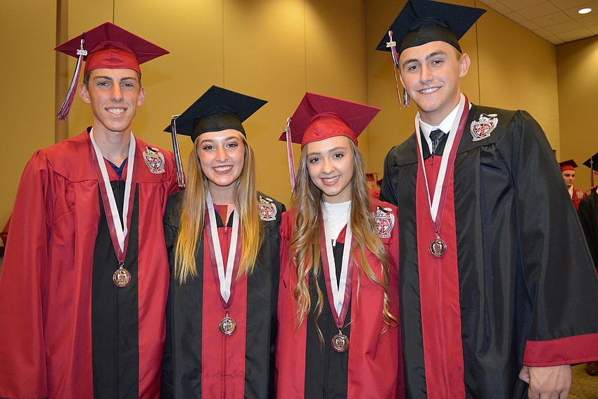 Jonathan Vercammen, Madison Dylenski, Logan Tackett and Chase Owen proudly wear their school's colors.