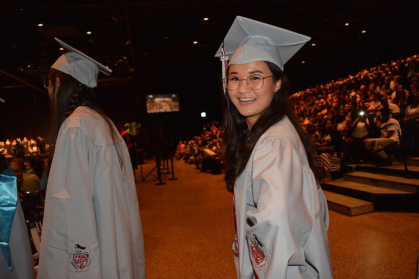Karissa Bolle smiles and gestures towards friends she sees in the crowd.