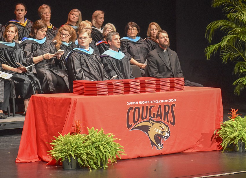 The Van Wezel stage was filled with bright red diploma covers ready to be handed to the graduates.