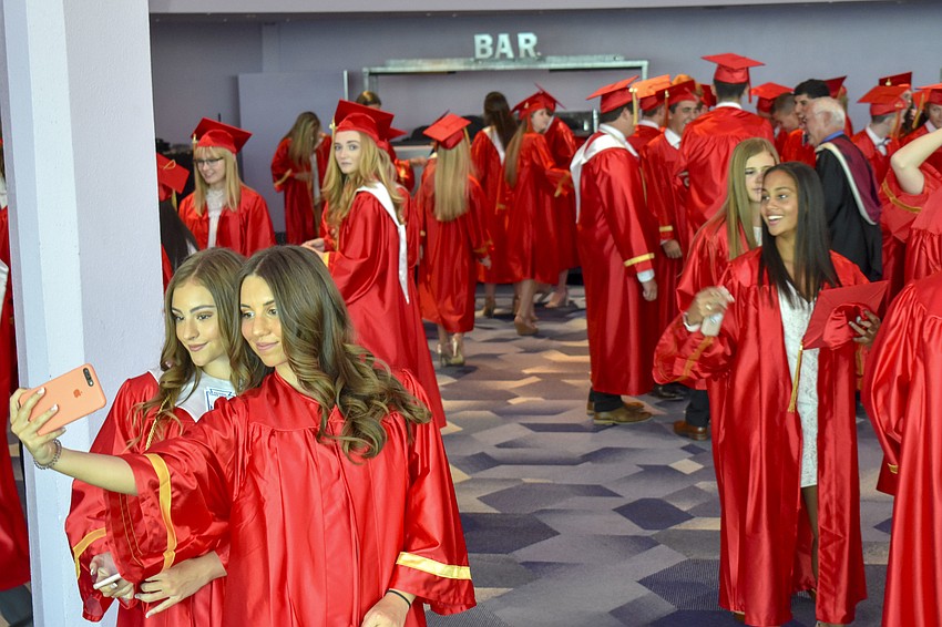 Sydney Hill and Rachel Consiglio break away from the crowd to snap a selfie before the ceremony.