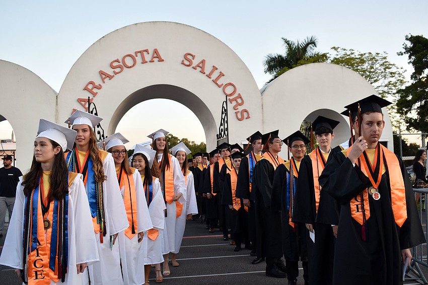 Graduates file into the stadium.