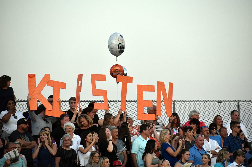 One graduate's family held up letters spelling out her name.