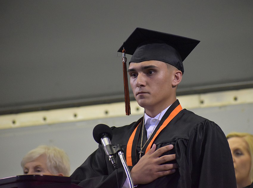 Senior Adam Ortega leads the crowd in the pledge of allegiance.
