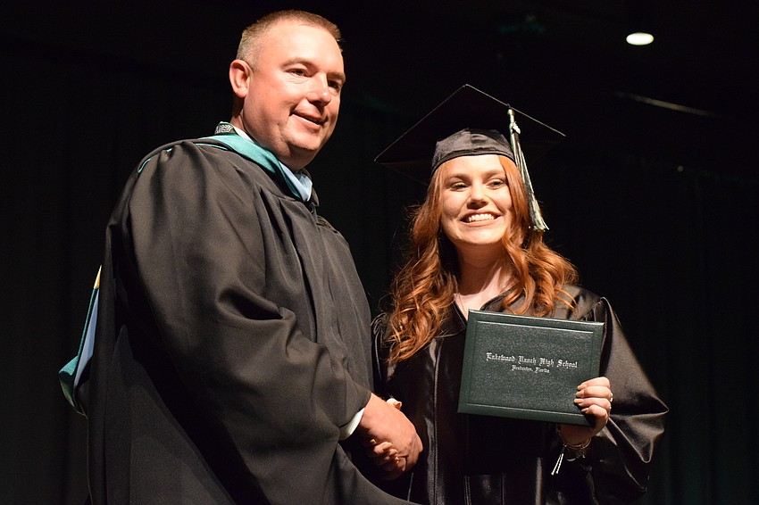 Principal Dustin Dahlquist and Payton Rypel pose for a picture after Rypel received her diploma.