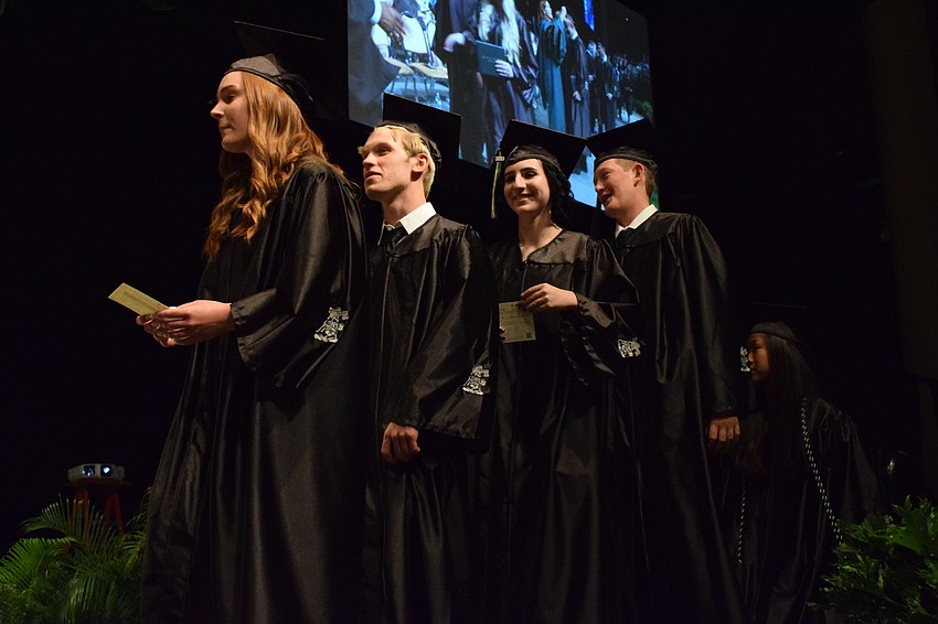 Seniors prepare to walk across the stage and receive their diploma.