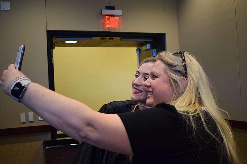 Graduate Paulina Medrzycki and teacher Tana Phelps take a selfie together.