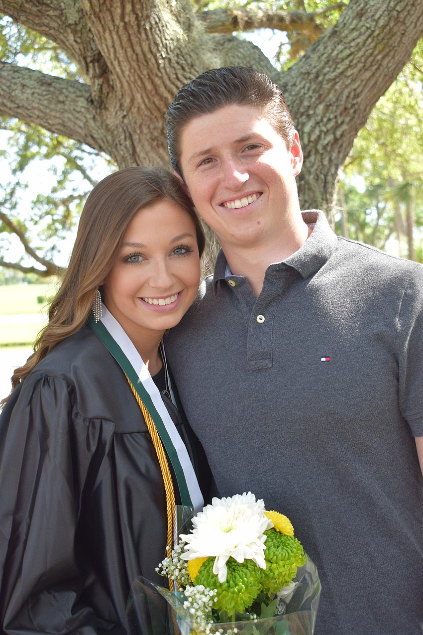 Graduate Regan Briggs visits with her boyfriend, Anthony Marino, before the ceremony.