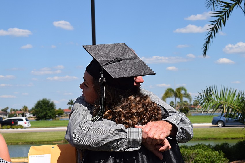 Madeline Coiner hugs her dad, Tim Coiner, after she graduates.