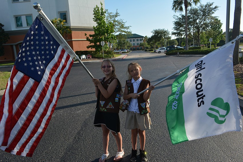 East County 9-year-old Christie Humphreys and Sarasota 9-year-old Allegria Ferreira had big responsbilities for Troop 42 in the parade.