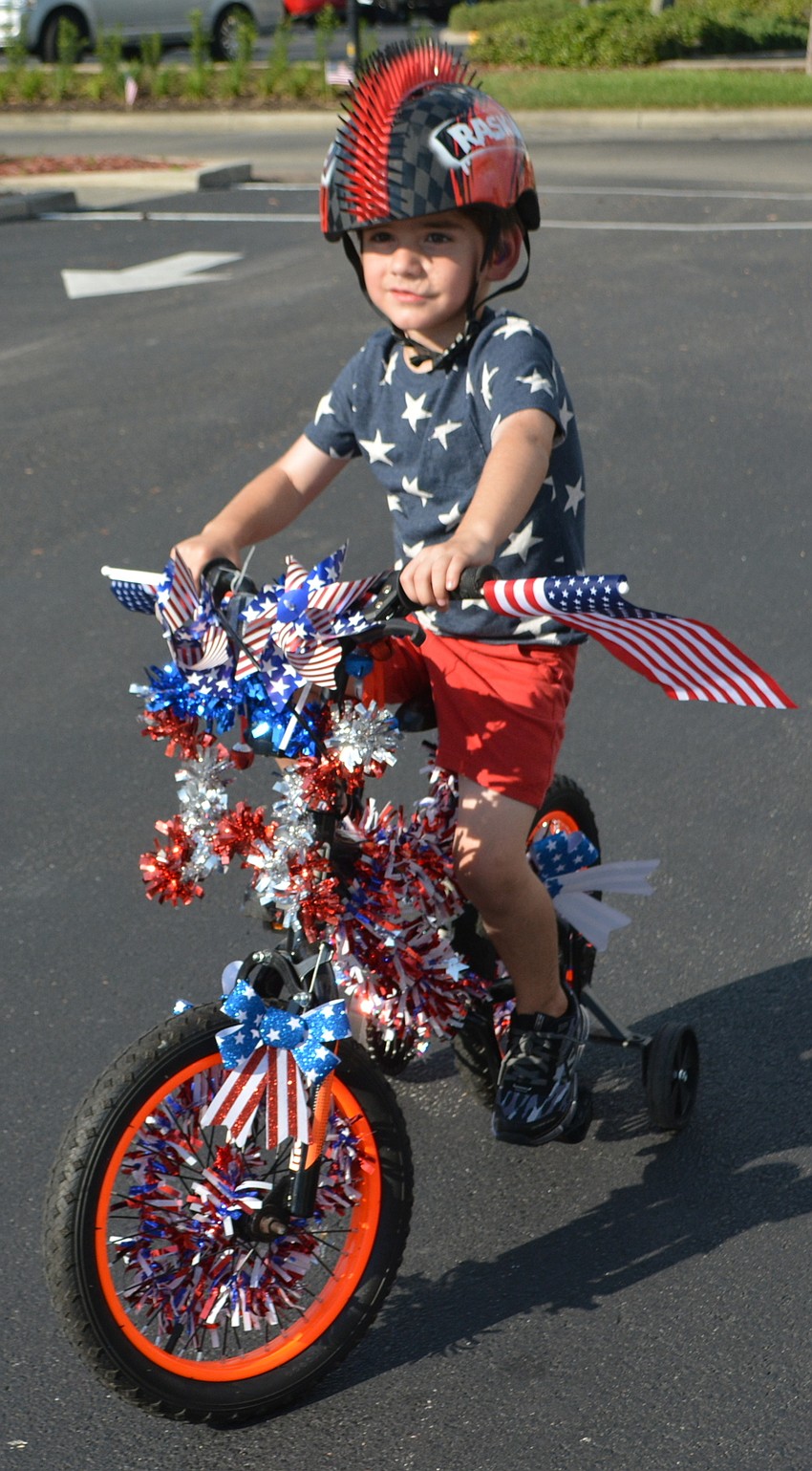 Lakewood Ranch 5-year-old Alex Stark shows off his entry in the decorated bicycle contest.