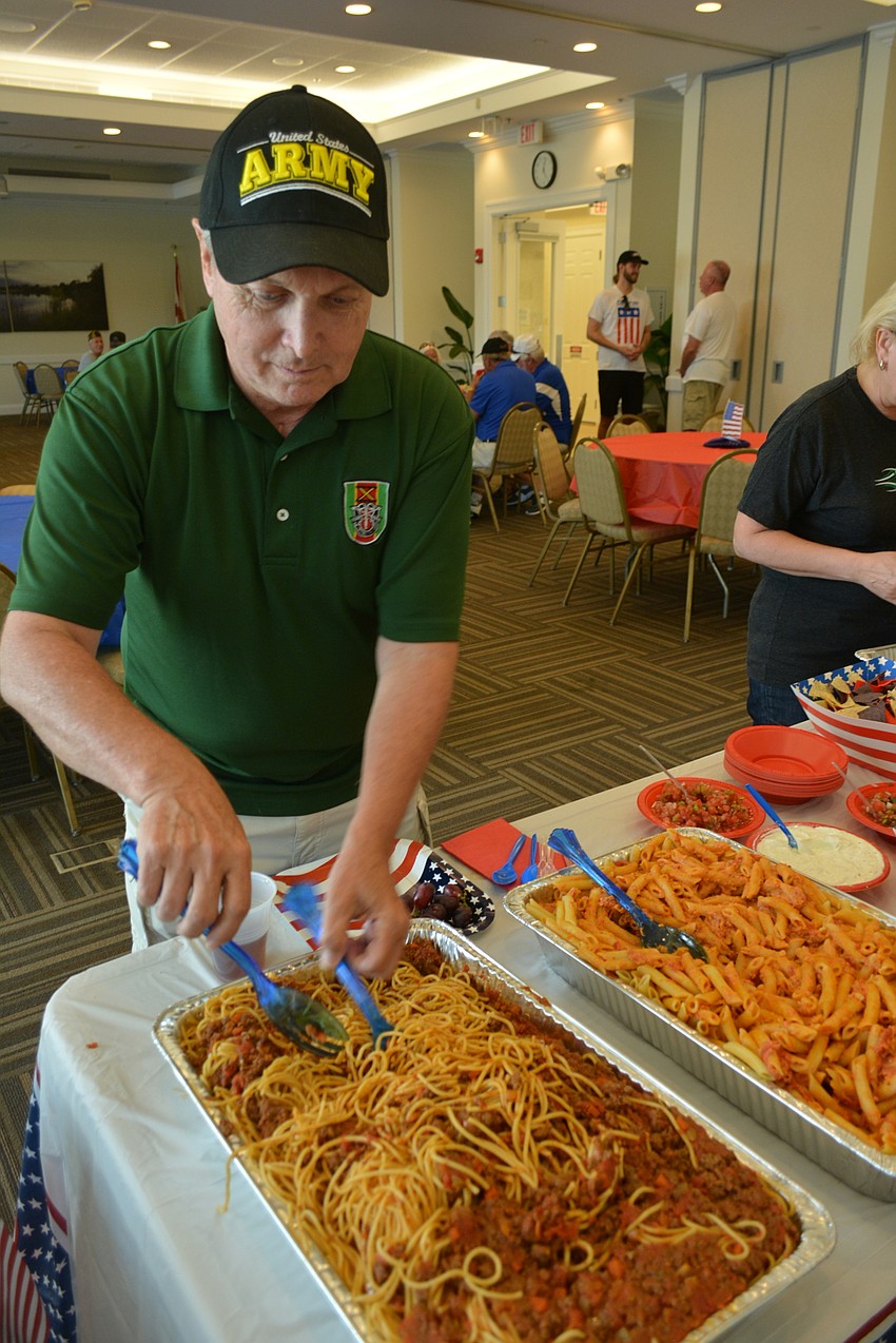 Creekwood's Thomas Carter, a retired captain with the 82nd Airborne Division and a special forces soldier, enjoys a meal for the veterans at Town Hall.