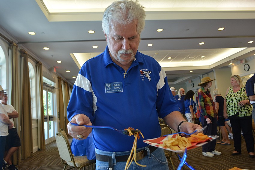 Richard Rajsky of the Gulf Coast Corvette Club enjoys a spread at Lakewood Ranch Town Hall before the parade. The Corvette club supplied cars for the veterans to ride in during the parade.