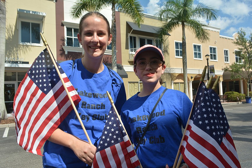 Lindsey Hyer and Kyla Munoz, Lakewood Ranch High juniors and members of the Key Club, volunteered to put out American flags before the parade.