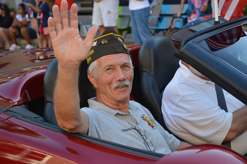 Vietnam veteran Charlie Busack gets his ride down Main Street in a Corvette.