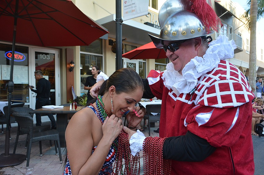 East County veteran Jennifer Webber is honored with beads by Crewe of De Soto's Donnie Olmsted.