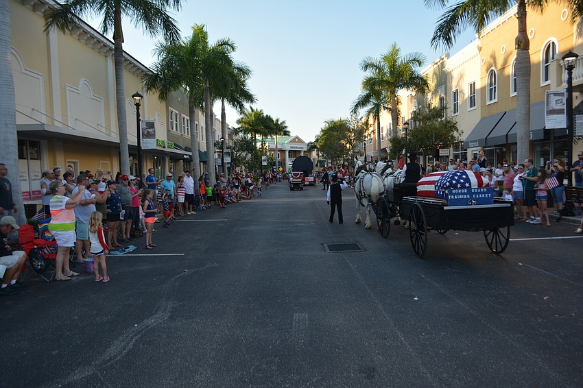 A horse-draw carriage carrying a soldier's coffin closed the parade as always.