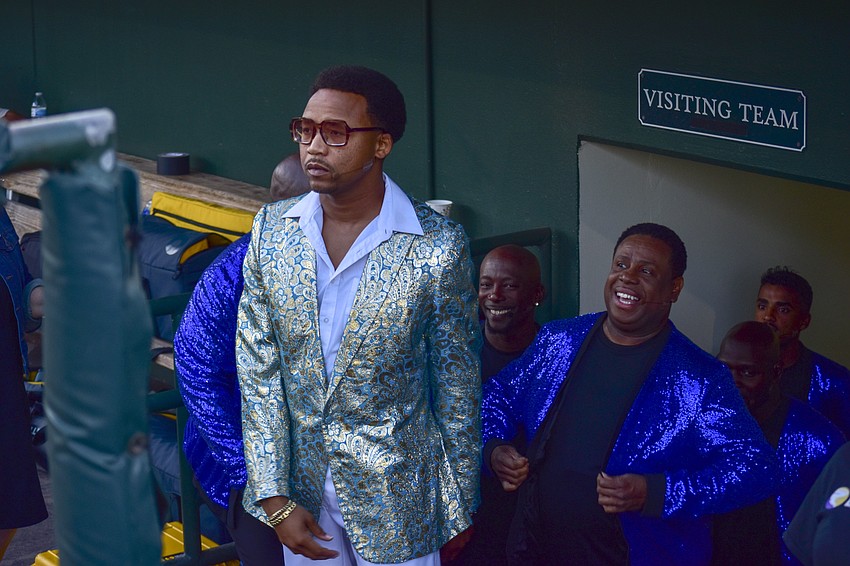 Earley Dean, master of ceremonies, waits to lead out the Soul Crooners in the dugout.