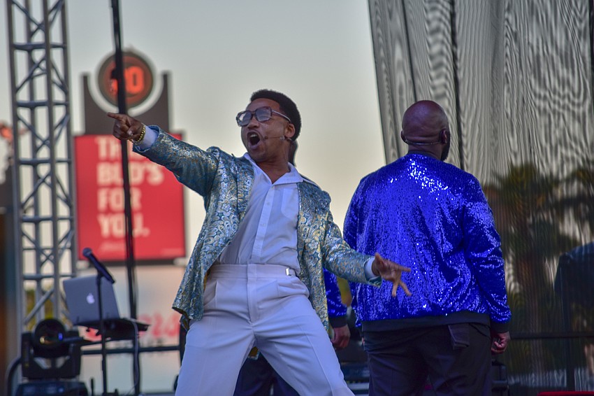 Earley Dean revs up to crows before the Crooners perform.