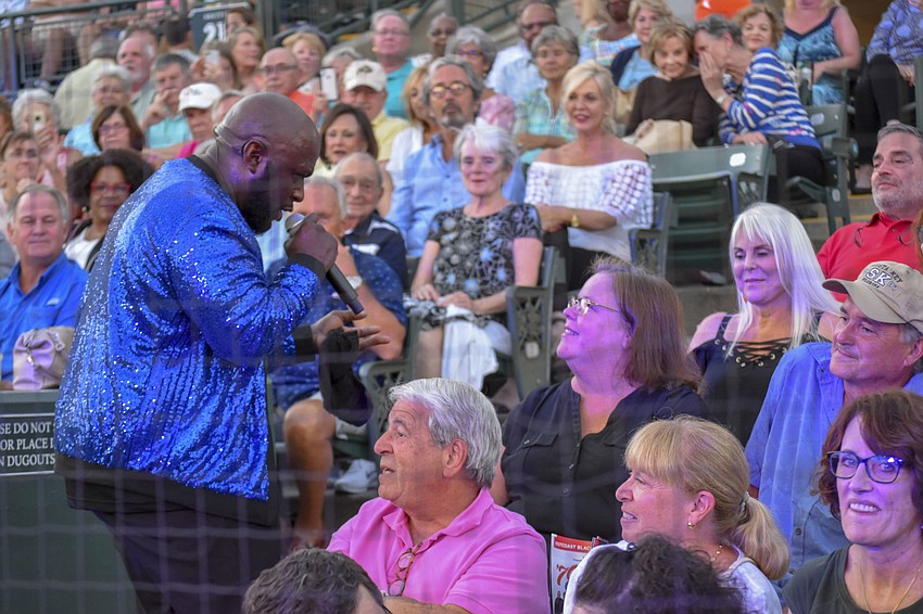 Leon S. Pitts II runs off stage and through the crowd to serenade audience members.