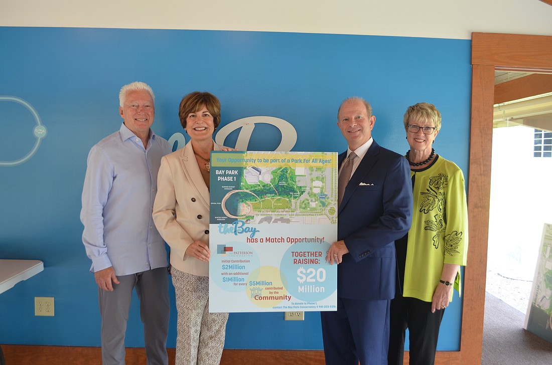 A.G. Lafley, Cathy Layton, Ric Gregoria and Debra Jacobs pose around the board announcing The Patterson Foundation&#39;s contribution toward the first phase of the bayfront project.