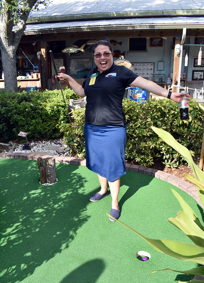 After several attempts, Debbie Shaffer is excited to have putt the ball in the hole.