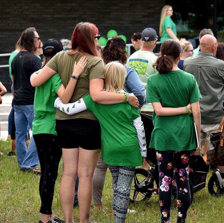 Community members held on to each other as Miller's classmates spoke.