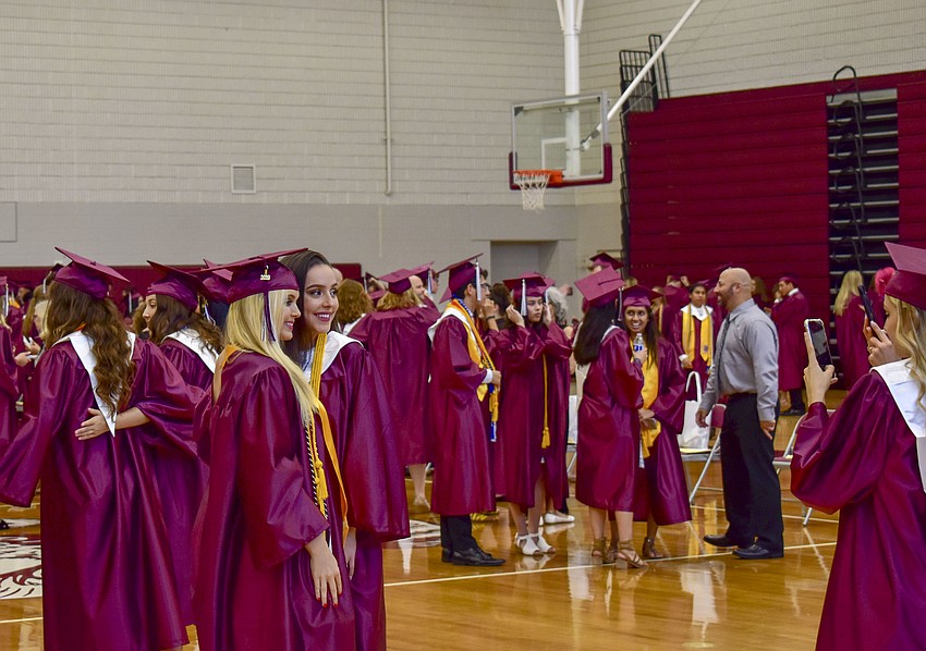 Seniors pose with friends before the ceremony begins.
