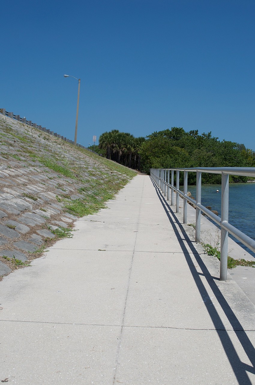 A walkway under the New Pass Bridge leads from parking at Overlook Park to the nature preserve.