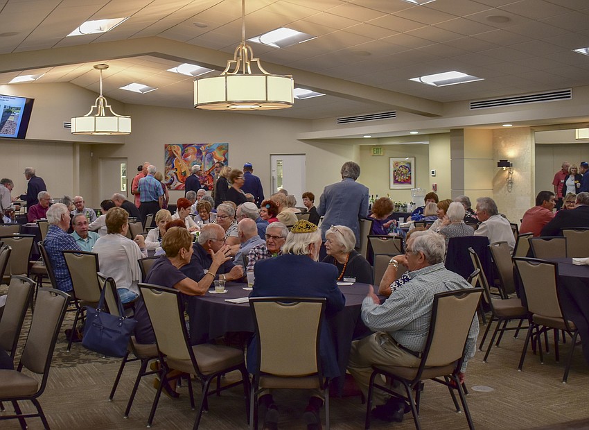 Members of the Brotherhood and their families talk over dinner.