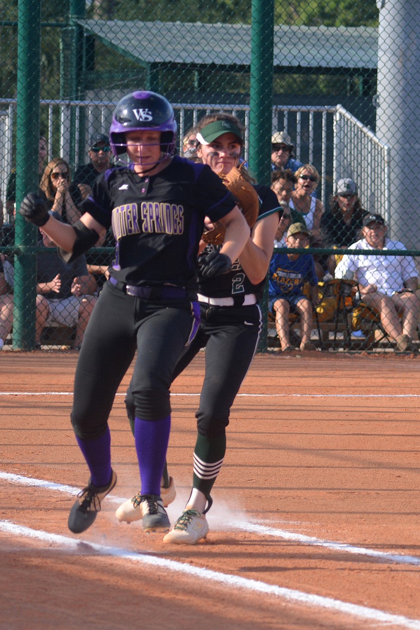 Junior first baseman Avery Goelz (right) tags out Winter Springs batter Kaley Mudge.