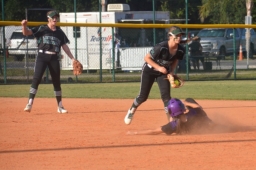 Lakewood Ranch freshman second baseman Kelsey Vogel looks to the umpire for confirmation after tagging out a Winter Springs player on a steal as shortstop Kali Reis celebrates.