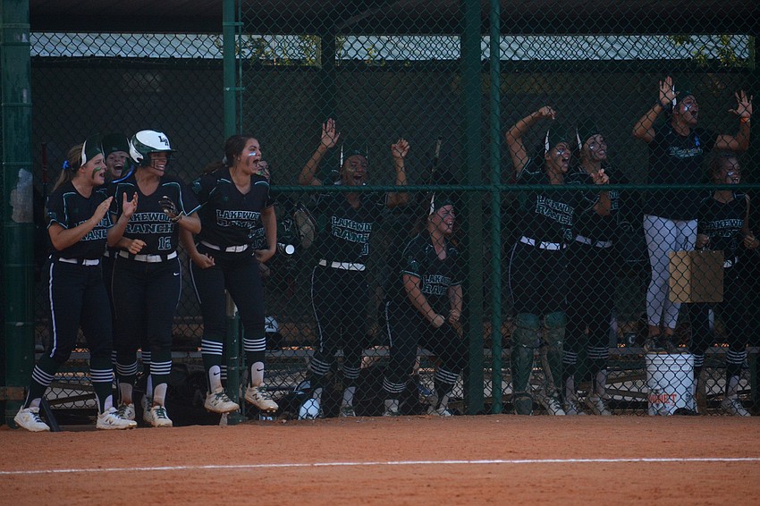 The Lakewood Ranch dugout goes nuts after McKenzie Clark triples in the seventh inning.