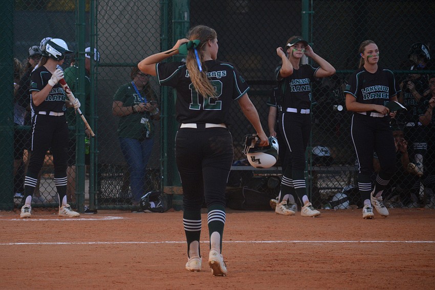 Senior third baseman Maddie Koczersut (12) walks off the field for the last time after the game's final out.