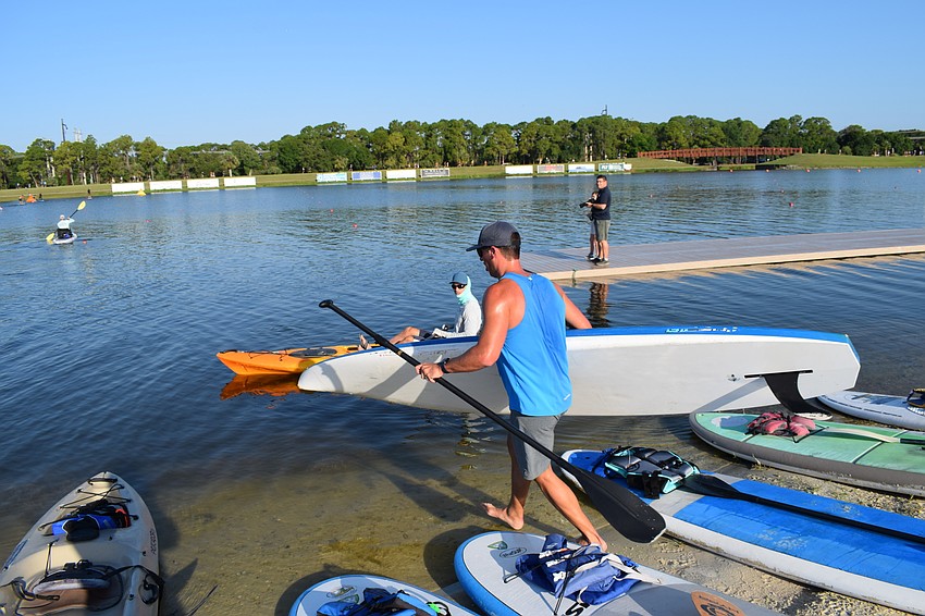 Racers collected their breath before rushing to the paddleboard and heading into the water.