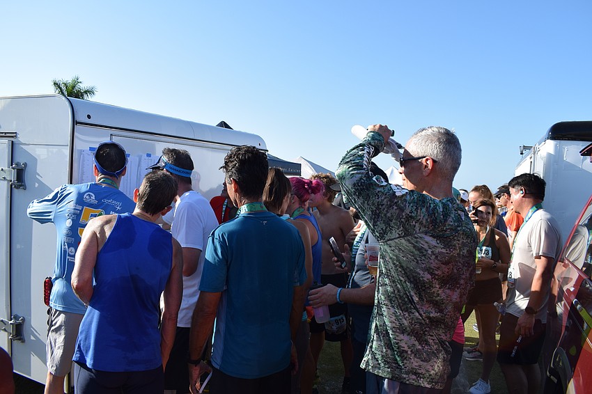 Racers crowd the beer truck where race results are posted.