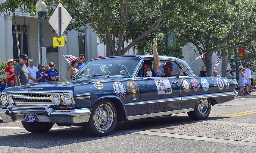 One of the Valued Vets cars in the parade drives down Main Street.
