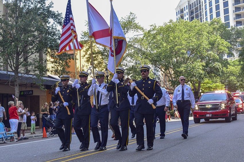 The Sarasota Fire Department leads several fire trucks down the parade path.