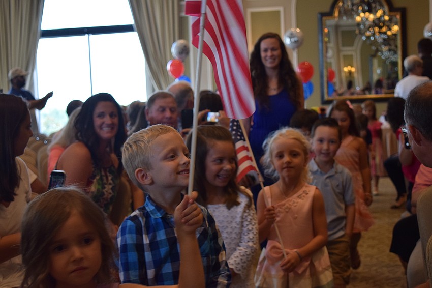 Students marched down the aisle with American flags before they got on stage, said the Pledge of Allegiance and sang the National Anthem.