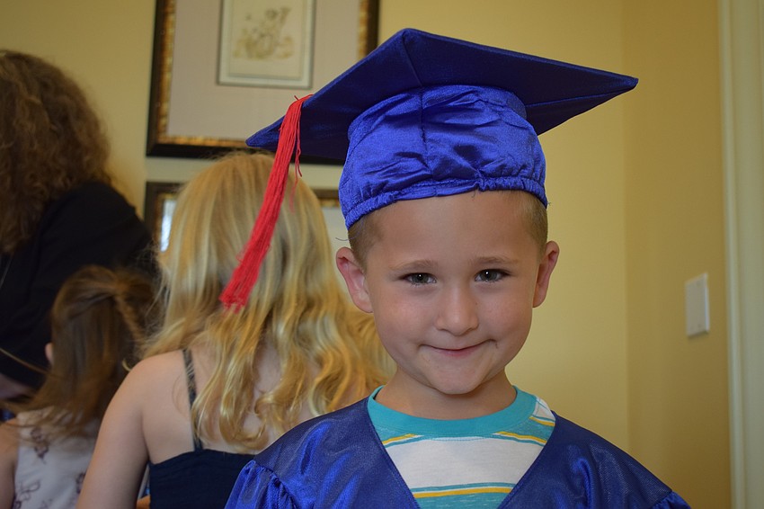 Graduating preschooler Levi Cotton donned his cap and gown before walking across the stage.