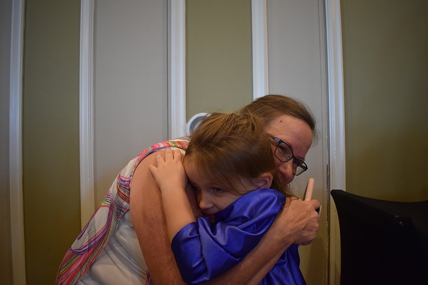 Harper Rigo, of Sarasota, hugged her grandma, Deanna Nicholas once the ceremony was over.
