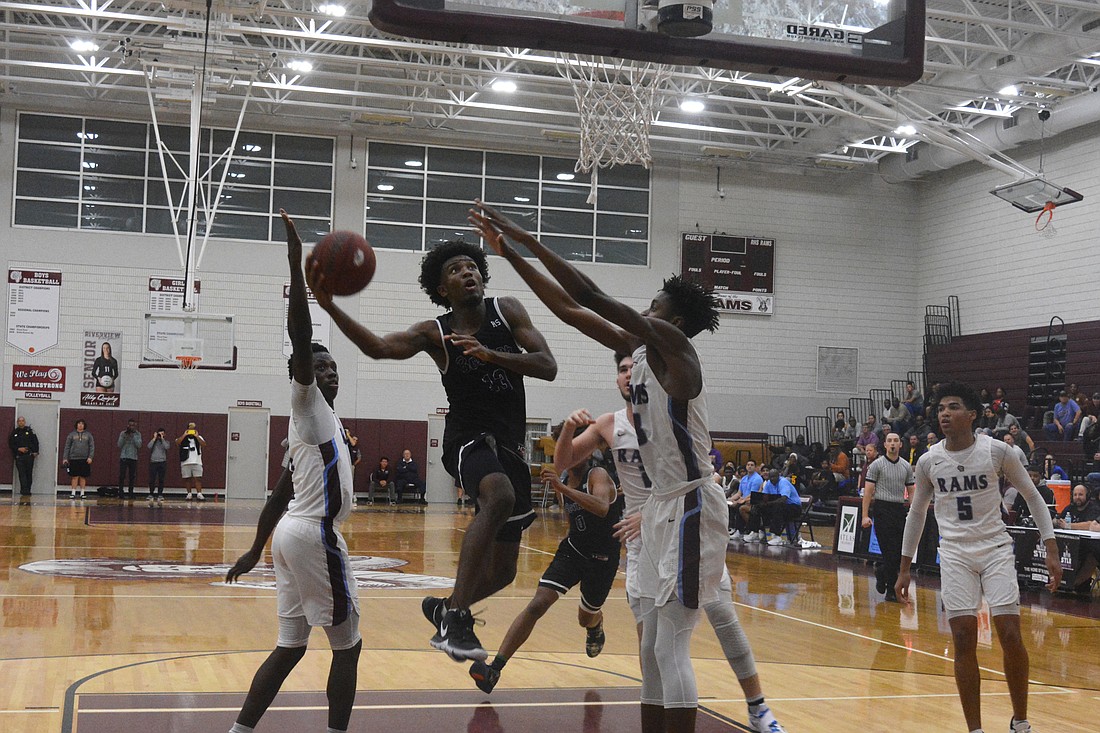 Booker&#39;s Jordan Clark weaves through the Riverview defense for a layup.