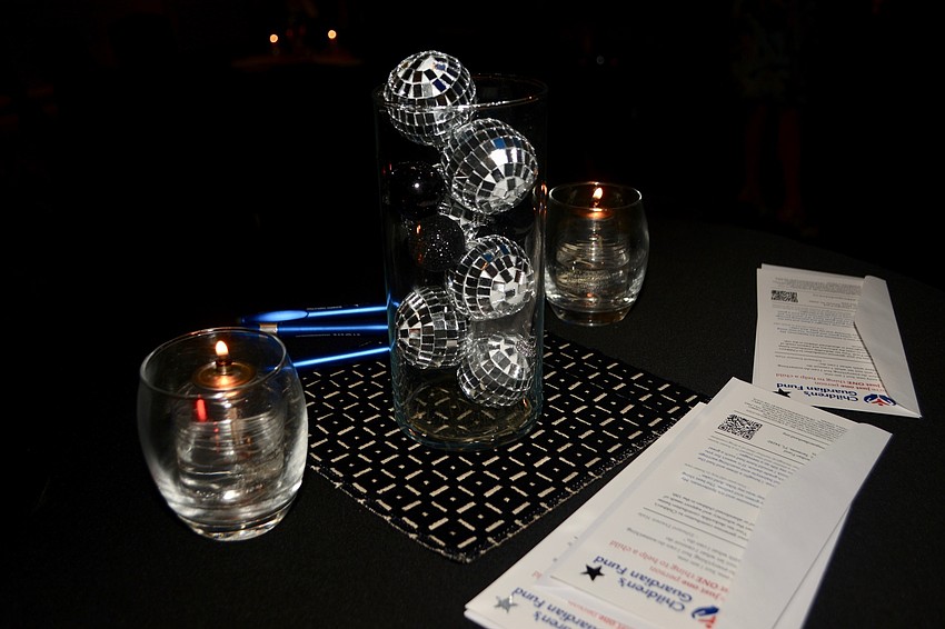Small disco balls served as the centerpiece for many tables