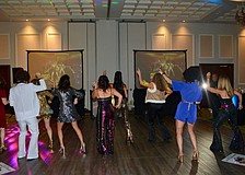 Attendees lined up on the dance floor to do the Hustle